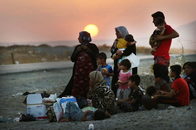 Thousands have fled the Sinjar town as Islamic State militants forced the Kurdish forces guarding the frontiers to retreat.