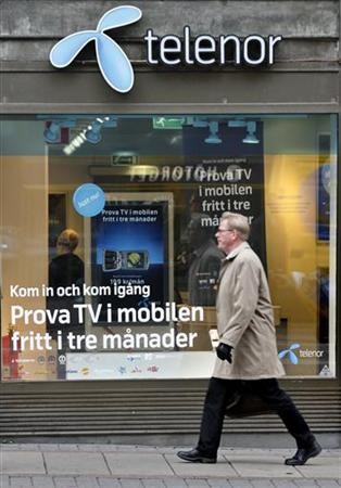 A pedestrian walks past a Telenor store in central Stockholm