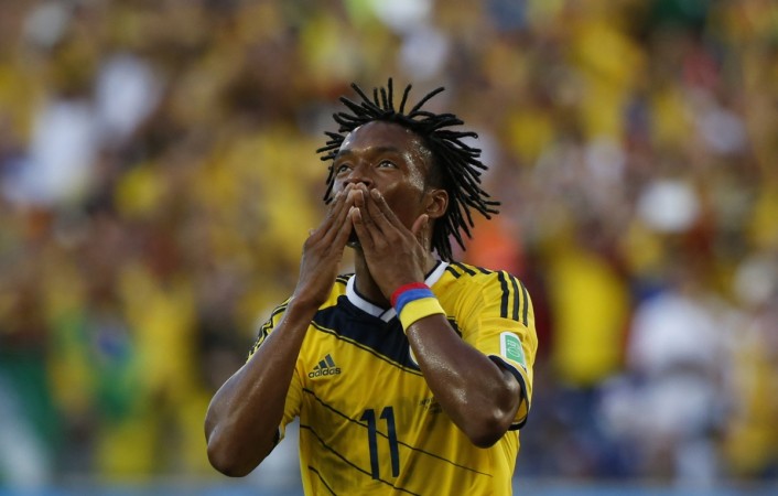 Colombia's Juan Cuadrado celebrates after scoring a penalty goal against Japan during their 2014 World Cup Group C match at the Pantanal arena. Juan Cuadrado