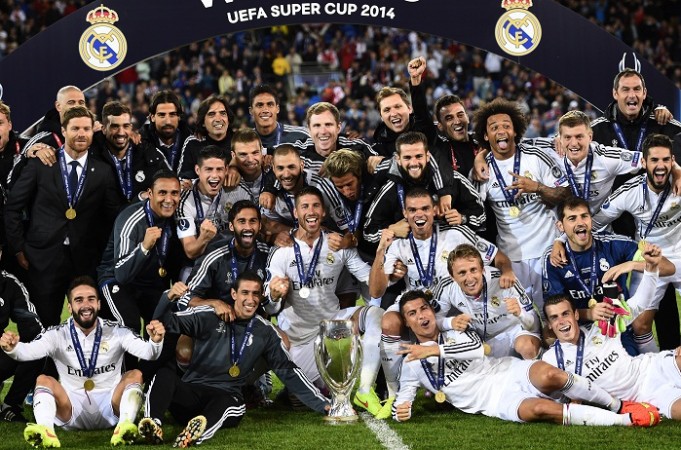 Real Madrid players celebrate with the UEFA Super Cup trophy after defeating Sevilla Real Madrid UEFA Super Cup