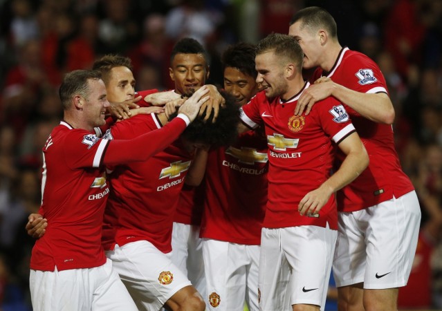 Manchester United's Marouanne Fellaini (C) celebrates after scoring the winning goal against Valencia with his teammates during their friendly soccer match at Old Trafford Manchester United vs Valencia