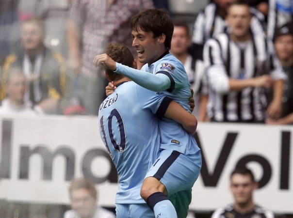 Manchester City's David Silva (R) celebrates with teammate Edin Dzeko after scoring a goal against Newcastle United during their English Premier League match at St James' Park Newcastle United vs Manchester City
