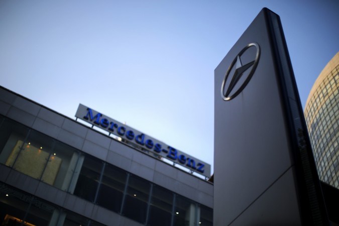 A Mercedes-Benz logo and sign are seen at a dealership