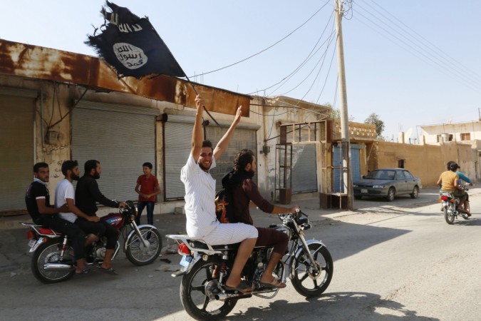 A resident of Tabqa city touring the streets on a motorcycle waves an Islamist flag in celebration after Islamic State militants took over Tabqa air base, near Raqqa city August 24, 2014. A resident of Tabqa city touring the streets on a motorcycle waves an Islamist flag in celebration after Islamic State militants took over Tabqa air base, in nearby Raqqa city August 24, 2014. I