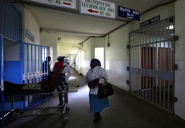 A patient is wheeled on a stretcher next to an isolation ward (R) set aside for Ebola related cases at the Kenyatta National Hospital (KNH) in the capital Nairobi August 19, 2014. Kenya Airways will suspend flights to Liberia's capital Monrovia and Sierra Leone's capital Freetown due to the Ebola outbreak in West Africa. Reuters