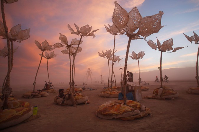 Revellers take a break during the week-long festival at an art installation called 'Pulse & Bloom'. Festival-goers lounge around an art installation called 'Pulse & Bloom'.(Jim Urquhart / Reuters)