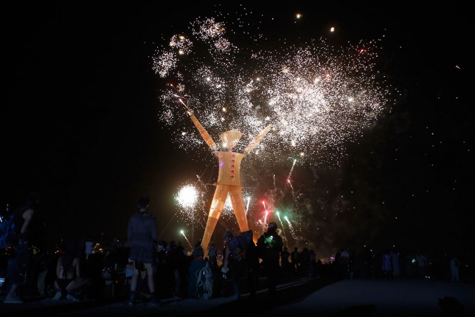 Thousands enjoyed the fireworks before the Burning Man was set on fire. Thousands enjoyed the fireworks before the Burning Man was set afire.