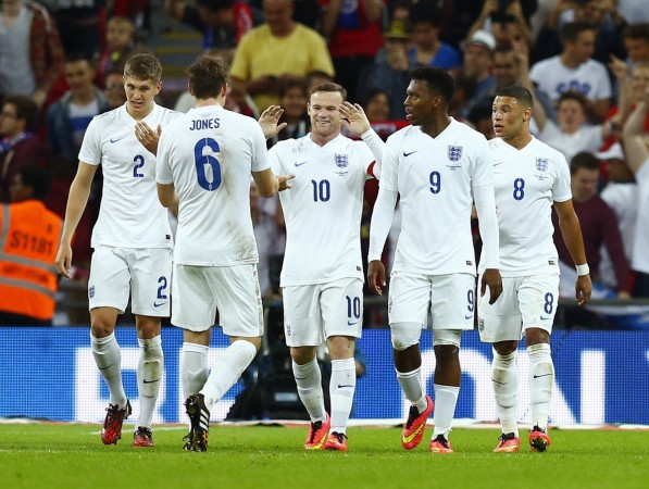England captain Wayne Rooney (C) celebrates with teammates after scoring his penalty during their international friendly match against Norway at Wembley England