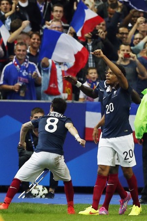 France's Loic Remy (R) celebrates with team mate Mathieu Valbuena (L) after scoring against Spain during their international friendly match at the Stade de France France