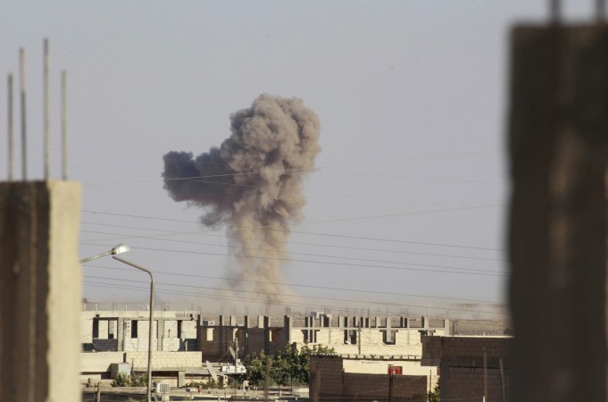 Smoke rises during what activists said was an air raid by forces of Syria's President Bashar Al-Assad around al-Tabqa military base at a government-controlled airport that is surrounded by militants, west of Raqqa city. ISIS
