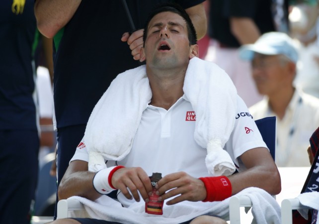 Novak Djokovic of Serbia cools off with an ice towel during a break in play against Kei Nishikori of Japan in their semi-final match at the 2014 U.S. Open. Novak Djokovic
