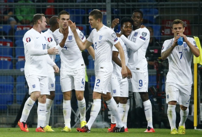 England's Danny Welbeck (2R) celebrates with Raheem Sterling (3R) and other team mates after scoring a goal against Switzerland during their Euro 2016 qualifying match at the Sankt Jakob-Park stadium in Basel. England