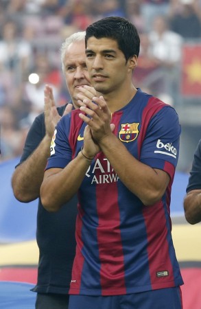 Luis Suarez applauds to his supporters during his presentation at Nou Camp stadium in Barcelona Luis Suarez