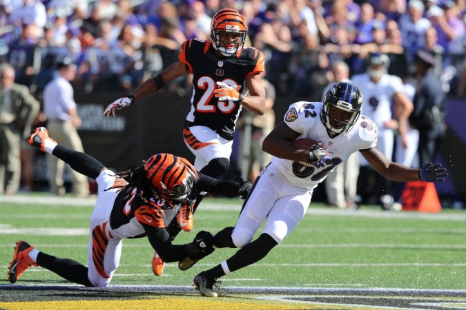 Baltimore Ravens wide receiver Torrey Smith (82) runs for a 25 yard gain before being tackled by Cincinnati Bengals safety Reggie Nelson (20) at M&T Bank Stadium. baltimore ravens
