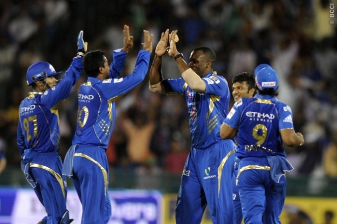 Mumbai Indians celebrate a wicket against the Lahore Lions in their CLT20 game Mumbai Indians Pollard Ojha