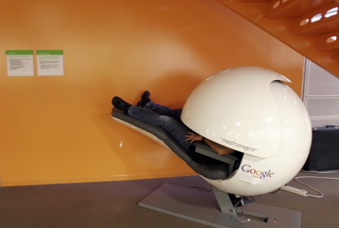 A Goggle employee takes a nap in a nap pod which blocks out light and sound at the Google headquarters in Mountain View, California A Goggle employee takes a nap in a nap pod