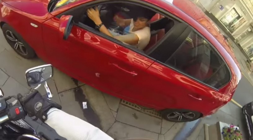 The anonymous woman throws cigarette buds into the car of a litterer Russian Woman Throws Back the Litter into the Cars of Litterers