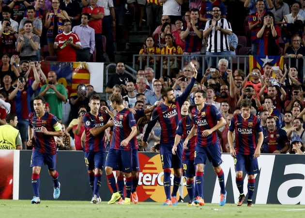 Barcelona's Gerard Pique celebrates his goal with teammates against Apoel FC during their Champions League soccer match at Nou Cap stadium in Barcelona Barcelona vs APOEL