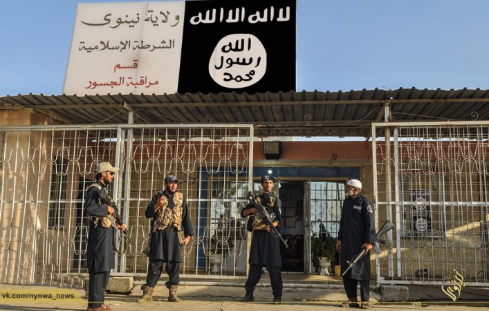 Islamic State Army police outside its newly setup police station in Mosul