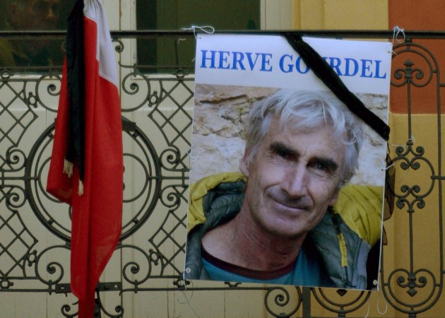 A portrait of mountain guide of Frenchman Herve Gourdel hangs near a French flag outside the town hall in Saint-Martin-Vesubie, September 24, 2014. Algerian militants have released a video that appears to show them beheading Gourdel who was kidnapped on Sunday A portrait of mountain guide of Frenchman Herve Gourdel hangs near a French flag outside the town hall in Saint-Martin-Vesubie, September 24, 2014. Algerian militants have released a video that appears to show them beheading Gourdel who was kidnapped on S