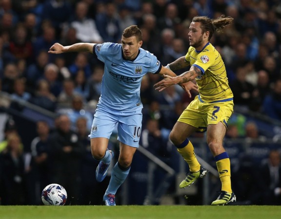 Manchester City's Edin Dzeko (L) holds off Sheffield Wednesday's Stevie May during their League Cup soccer match at Etihad Stadium in Manchester Manchester City
