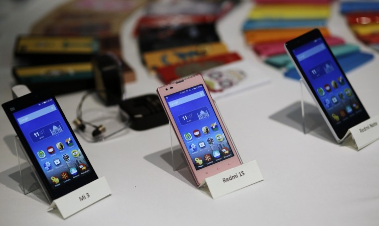 Three models of China's Xiaomi Mi phones are pictured during their launch in New Delhi July 15, 2014. China's Xiaomi said it intends to invest heavily in India as the budget smartphone maker launched on Tuesday its flagship Mi phone and other products in the world's third largest smartphone market, currently dominated by Samsung Electronics Co Ltd. REUTERS/Anindito Mukherjee Xiaomi smartphones on display