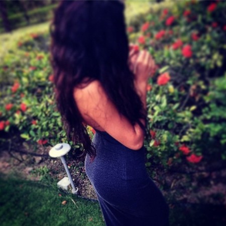 Selena Gomez near a bed of roses. Selena Gomez