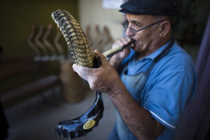 Shimon Keinan, blows a shofar in his workshop in Givaat Yoav in the Israeli occupied Golan Heights. Observant Jews blow the shofar, made from ram and antelope horns, in the Hebrew month of Elul, on the days leading to the Jewish new year and Yom Kippur, the Day of Atonement. Yom Kippur the Jewish Day of Atonement