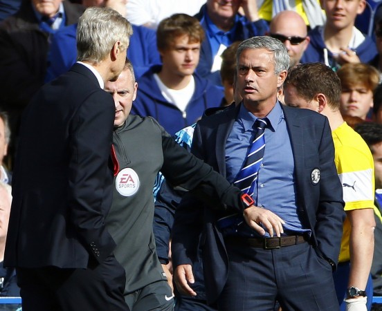 Chelsea manager Jose Mourinho (R) and his Arsenal counterpart Arsene Wenger (L) react during their English Premier League soccer match at Stamford Bridge Arsene Wenger