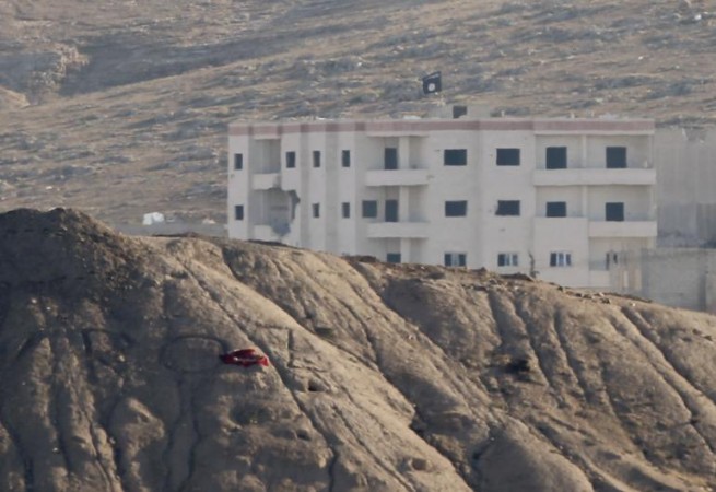 An ISIS flag on a building in Kobane An ISIS flag on a building in Kobane
