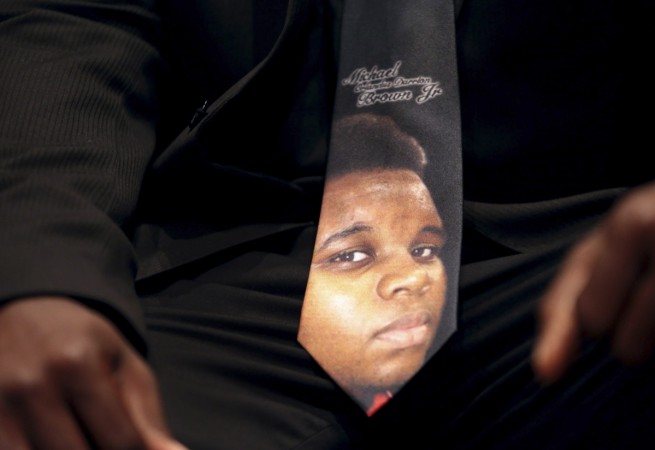 An unidentified man wears a tie decorated with a picture of Michael Brown, during funeral service at Friendly Temple Missionary Baptist Church in St. Louis, Missouri, August 25, 2014. An unidentified man wears a tie decorated with a picture of Michael Brown, during funeral service at Friendly Temple Missionary Baptist Church in St. Louis, Missouri, August 25, 2014.