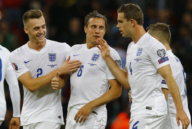 England's Phil Jagielka (2nd L) celebrates with teammates Callum Chambers (L) and Jordan Henderson after scoring the opening goal during their Euro 2016 qualifying match against San Marino at Wembley Stadium England
