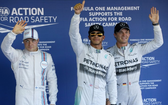 Williams Formula One driver Valtteri Bottas of Finland (L), Mercedes Formula One driver Lewis Hamilton of Britain (C) and his team mate Nico Rosberg of Germany, celebrate after the qualifying session of the Russian F1 Grand Prix in the Sochi Autodrom circuit Russian Grand Prix