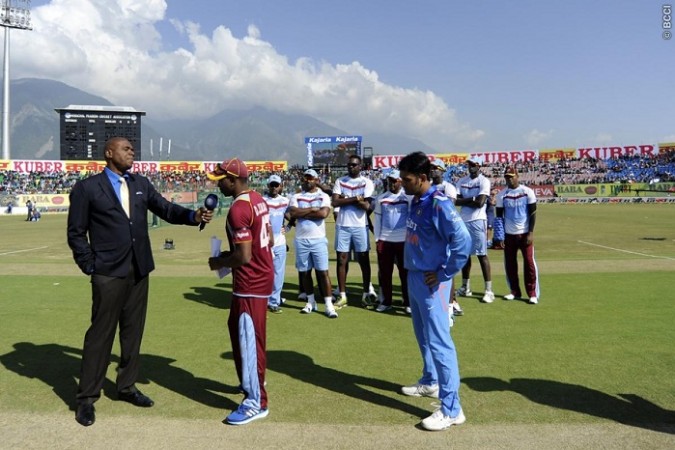 West Indies players stand behind their captain Dwayne Bravo during the toss as India skipper MS Dhoni looks on Dwayne Bravo West Indies MS Dhoni India