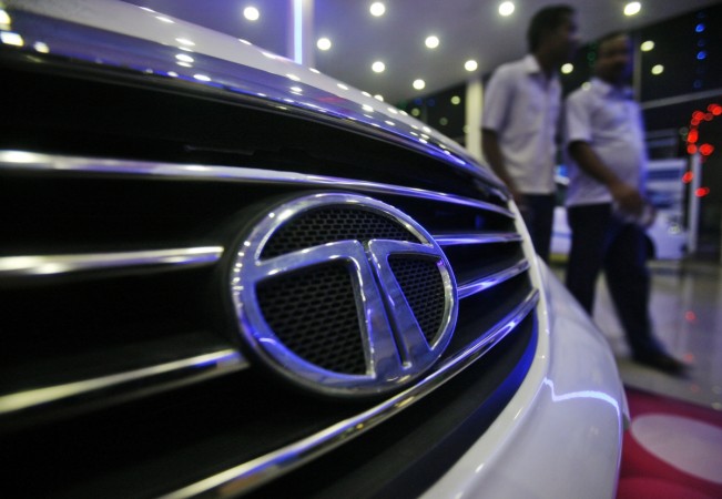 Men walk inside a Tata Motors showroom on the outskirts of Agartala, capital of India's northeastern state of Tripura on 7 November 2012 tata