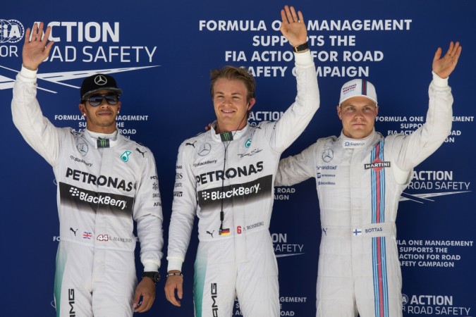 Mercedes drivers Nico Rosberg of Germany (C), team-mate Lewis Hamilton of Britain (L) and Williams driver Valtteri Bottas of Finland wave to fans and media, after completing the qualifying session of the F1 United States Grand Prix in Austin, Texas United States Grand Prix