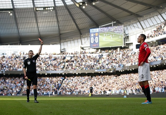 Manchester United defender reacts after receiving a red card from referee Michael Oliver Chris Smalling Manchester United Michael Oliver