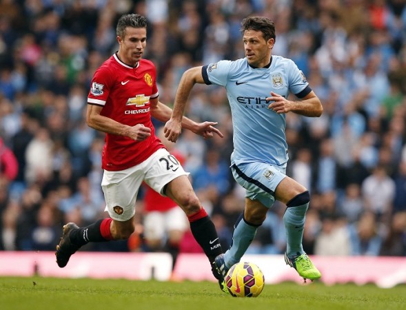 Manchester United forward Robin Van Persie and Manchester City defender Martin Demichelis battle for the ball during their English Premier League game Robin Van Persie Manchester United Martin Demichelis Manchester City