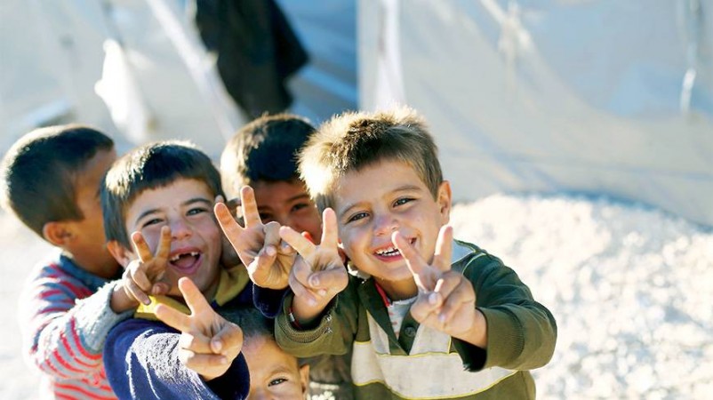 Kurdish refugee children from the Syrian town of Kobane flash victory signs in a camp in Suruc, Sanliurfa province.