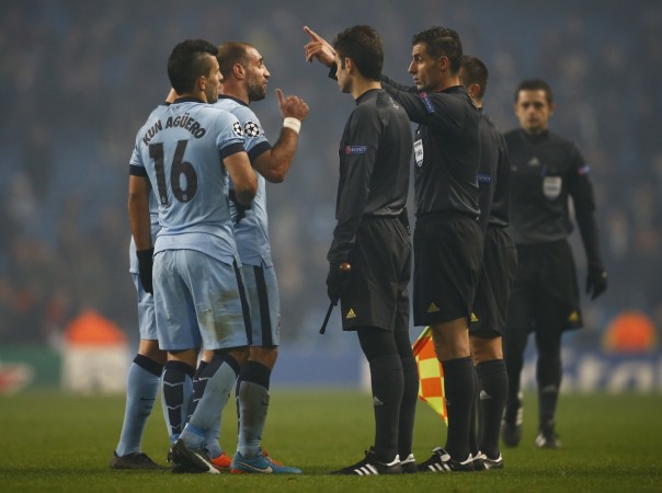 Manchester's City's Sergio Aguero (L) and Pablo Zabaleta (2nd L) argue with referee Tasos Sidiropoulos after their Champions League Group E match against CSKA Moscow at the Etihad stadium Manchester City