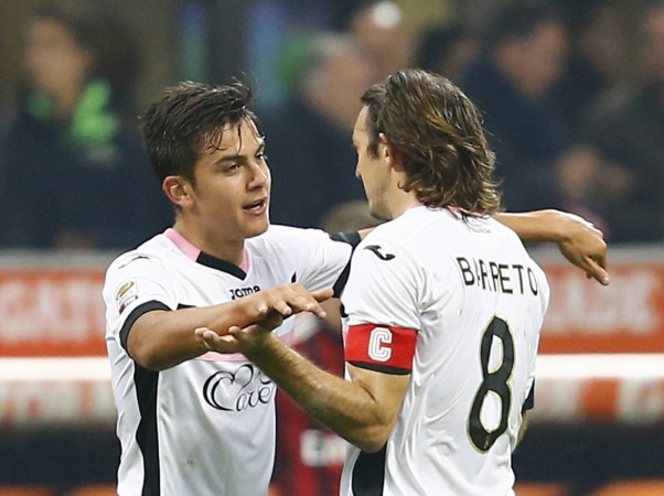 Palermo's Paulo Dybala (L) celebrates with teammate Edgar Osvaldo Barreto after scoring against AC Milan during their Serie A soccer match at San Siro stadium Paulo Dybala
