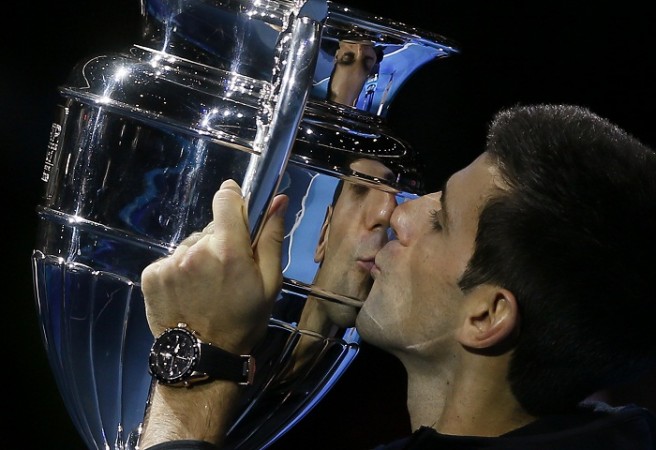 Novak Djokovic kisses the world number one trophy after defeating Tomas Berdych at the ATP World Tour Finals Novak Djokovic ATP World Tour Finals World Number One