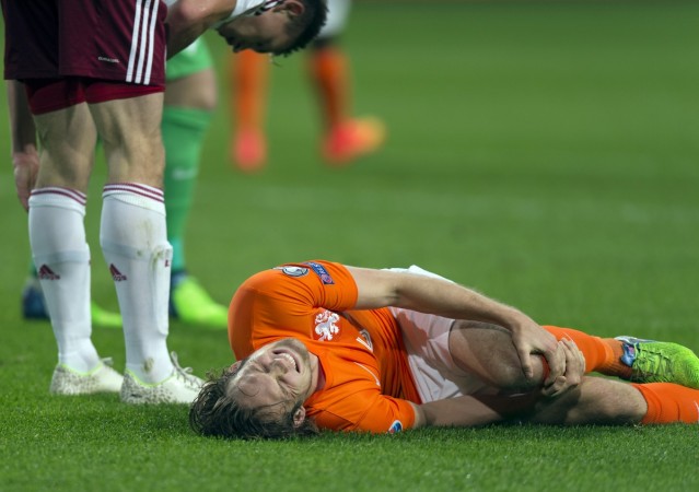 Daley Blind of the Netherlands lies injured after a challenge with Latvia's Eduards Viskanovs during their Euro 2016 Group A qualifying soccer match in Amsterdam November 16, 2014. Daley Blind