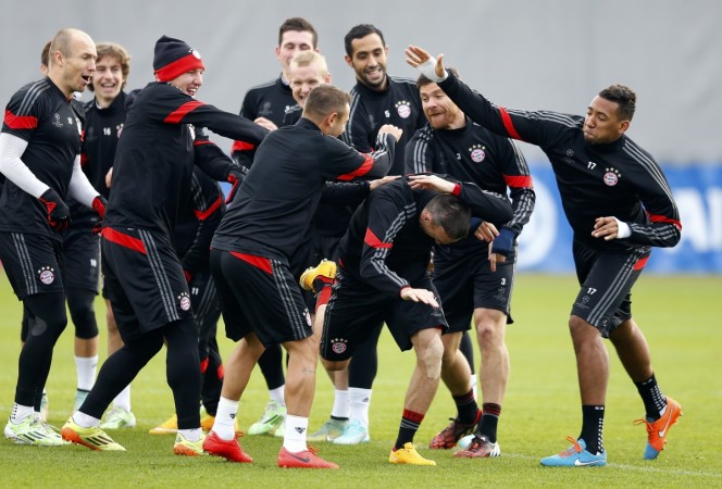 Bayern Munich players joke with Franck Ribery (2nd R, front) during a training session. Bayern Munich
