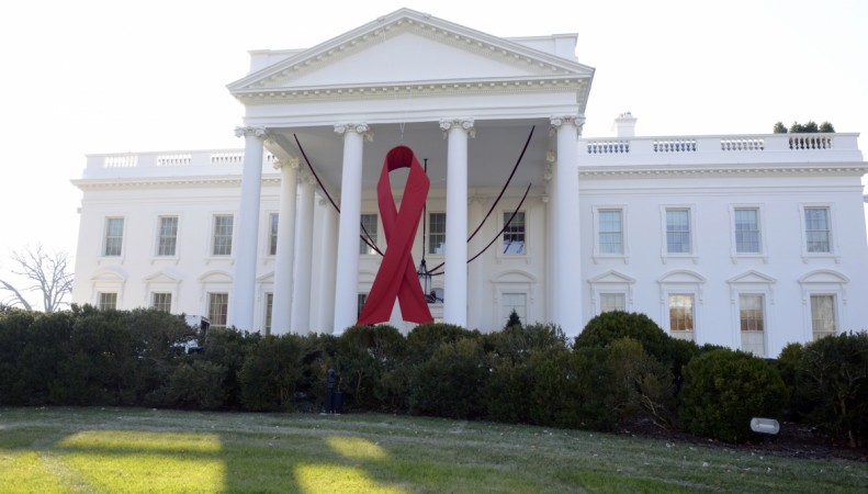 A giant red ribbon hangs from the North Portico of the White House to mark World AIDS Day, December 1, 2013. A giant red ribbon hangs from the North Portico of the White House to mark World AIDS Day, December 1, 2013,