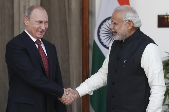 Russian President Vladimir Putin (L) shakes hands with India's Prime Minister Narendra Modi during a photo opportunity ahead of their meeting at Hyderabad House in New Delhi on 11 December 2014. modi putin