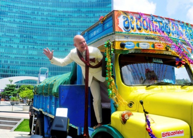 Jeff Bezos, founder and CEO of Amazon, stands on a supply truck during a photo opportunity at the premises of a shopping mall in Bangalore. Jeff Bezos