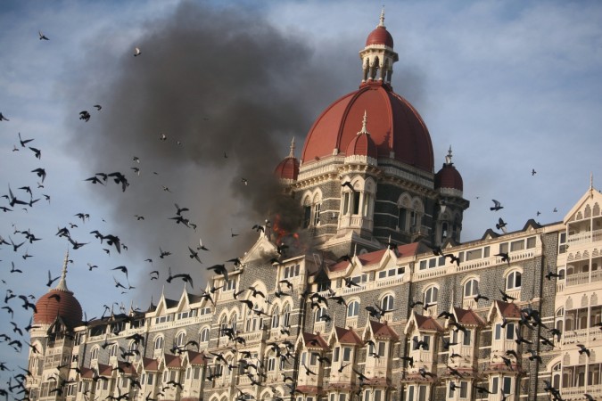 Pigeons fly near the burning Taj Mahal hotel in Mumbai on 27 November, 2008. Mumbai attacks