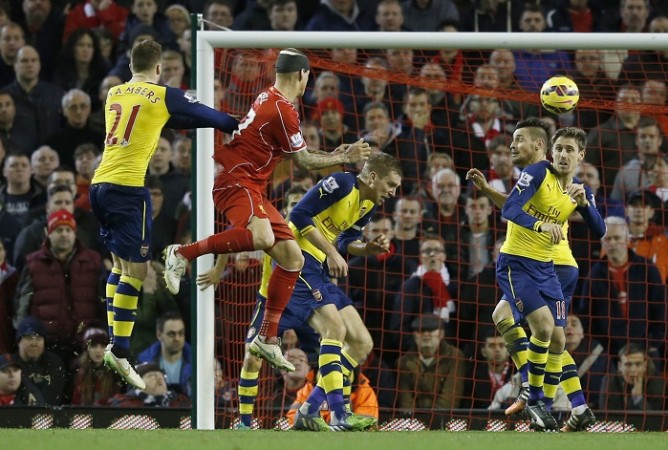 Liverpool defender Martin Skrtel heads in the equaliser against Arsenal in their English Premier League game Martin Skrtel Liverpool Calum Chambers Mertesacker Debuchy Monreal Arsenal