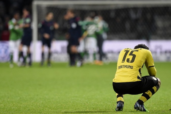 Mats Hummels reacts as Werder Bremen players celebrate their win over Borussia Dortmund in the Bundesliga Mats Hummels Borussia Dortmund